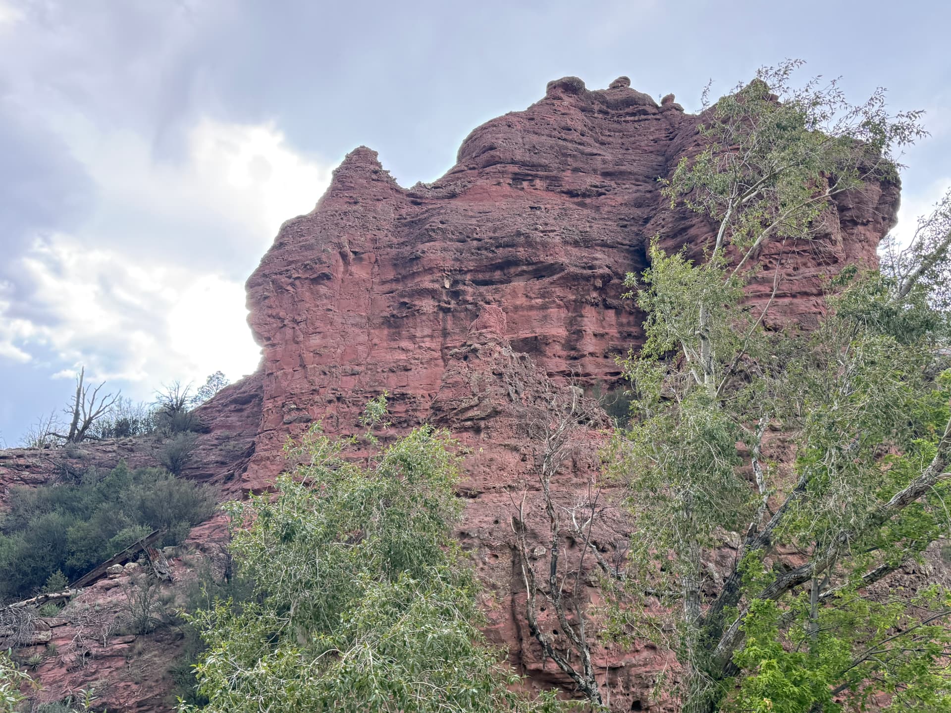 Red rock cliff in Sedona under a cloudy sky