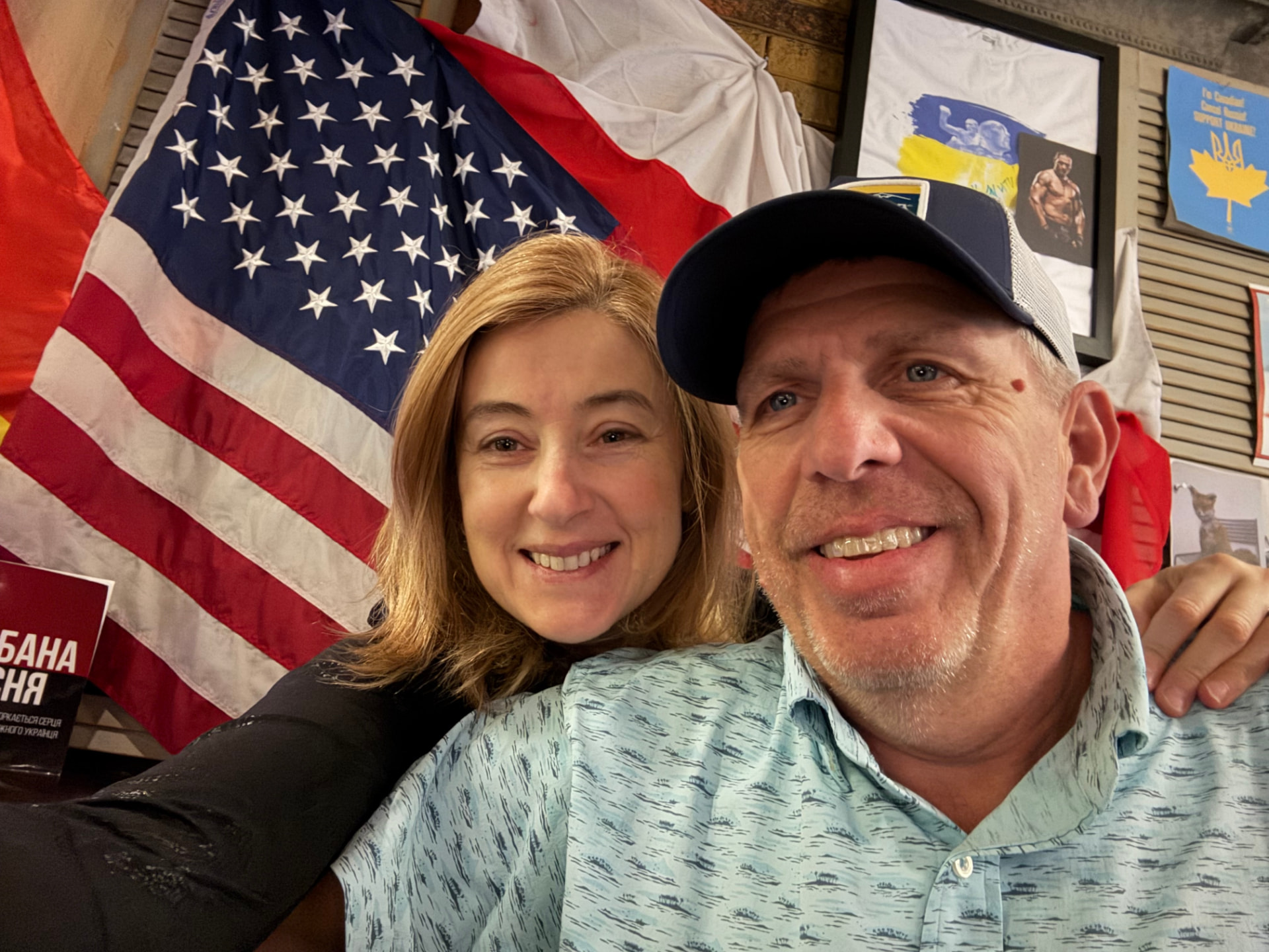 Natalia and her husband at a Ukrainian pub decorated with flags