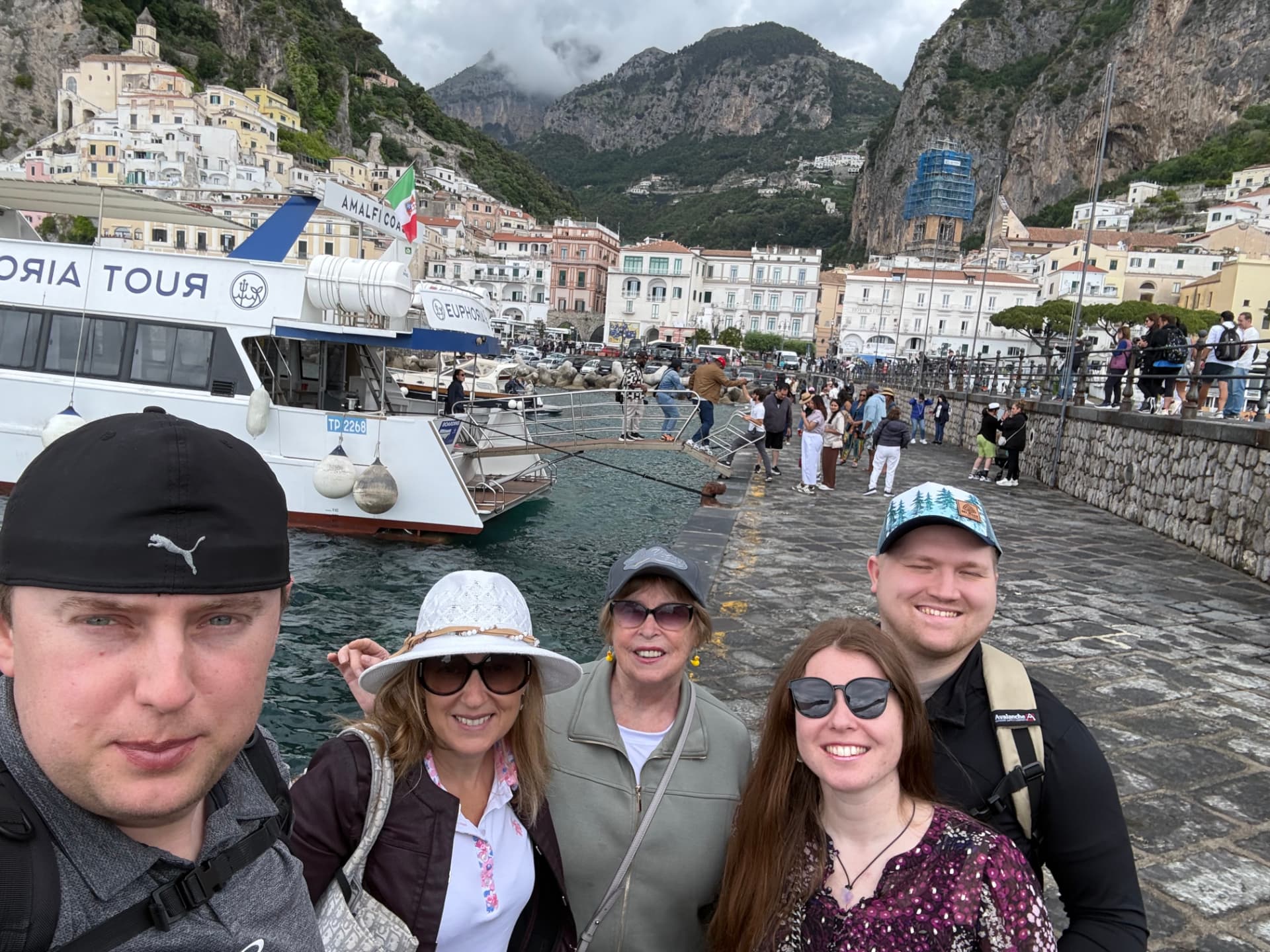 Natalia and family on the Amalfi harbor front with the town rising behind them