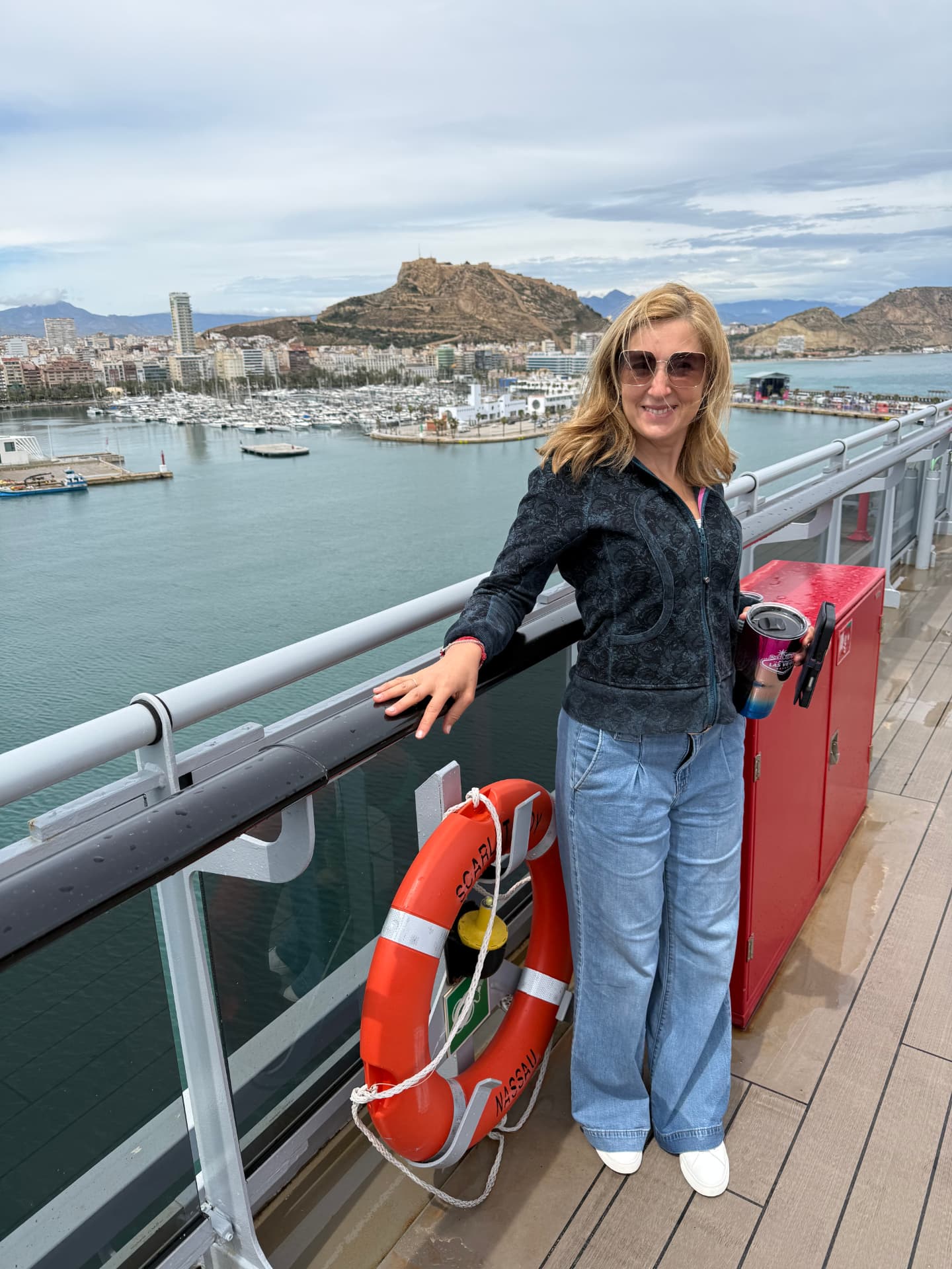 Natalia on the deck of Scarlet Lady overlooking a Mediterranean port