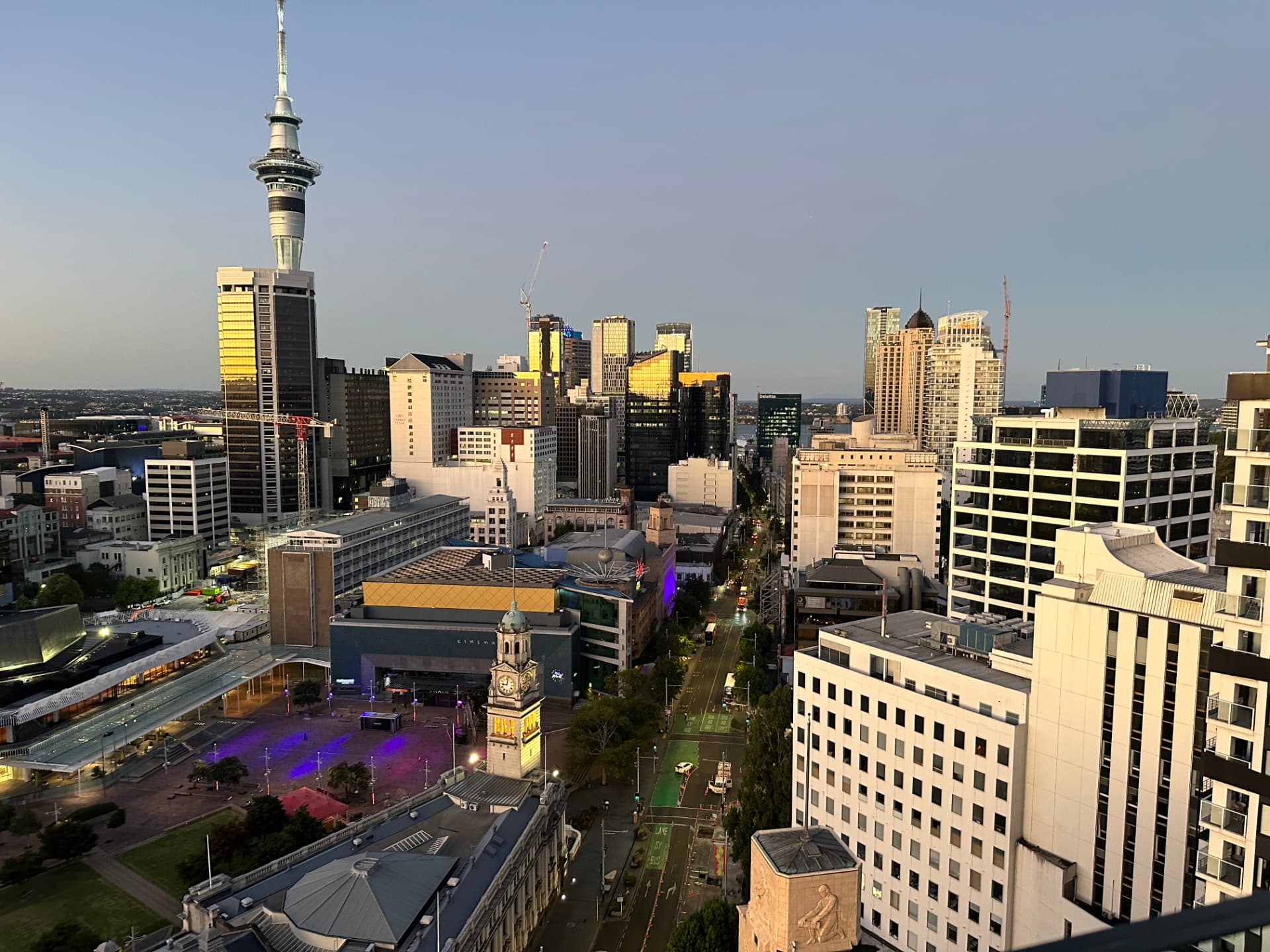 Auckland city centre and Sky Tower at dusk from a high balcony