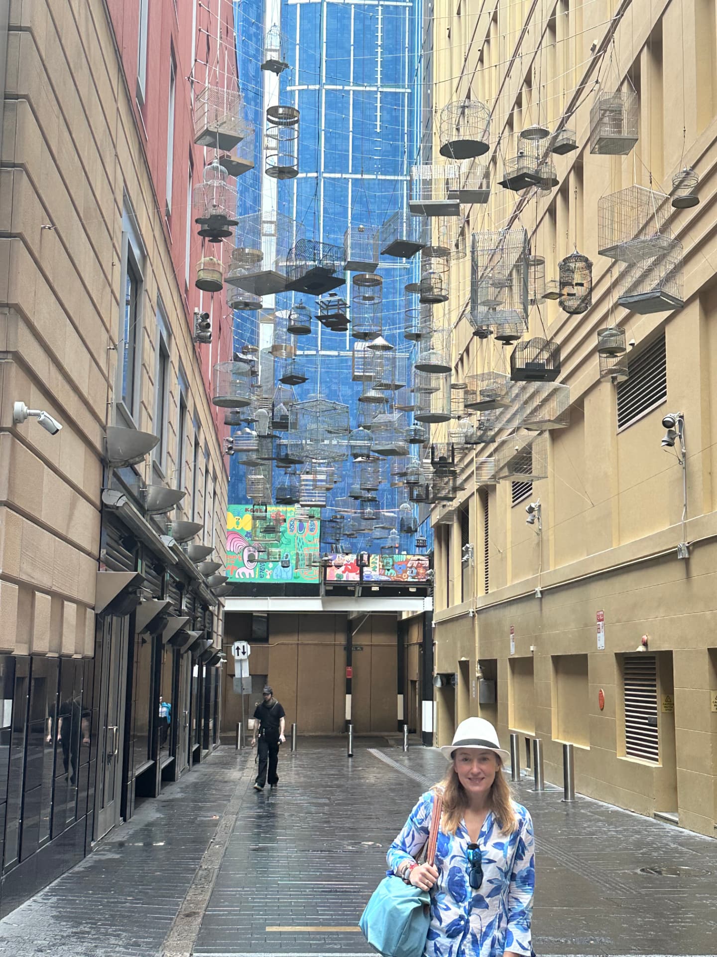 Natalia beneath the hanging birdcages of Angel Place in Sydney