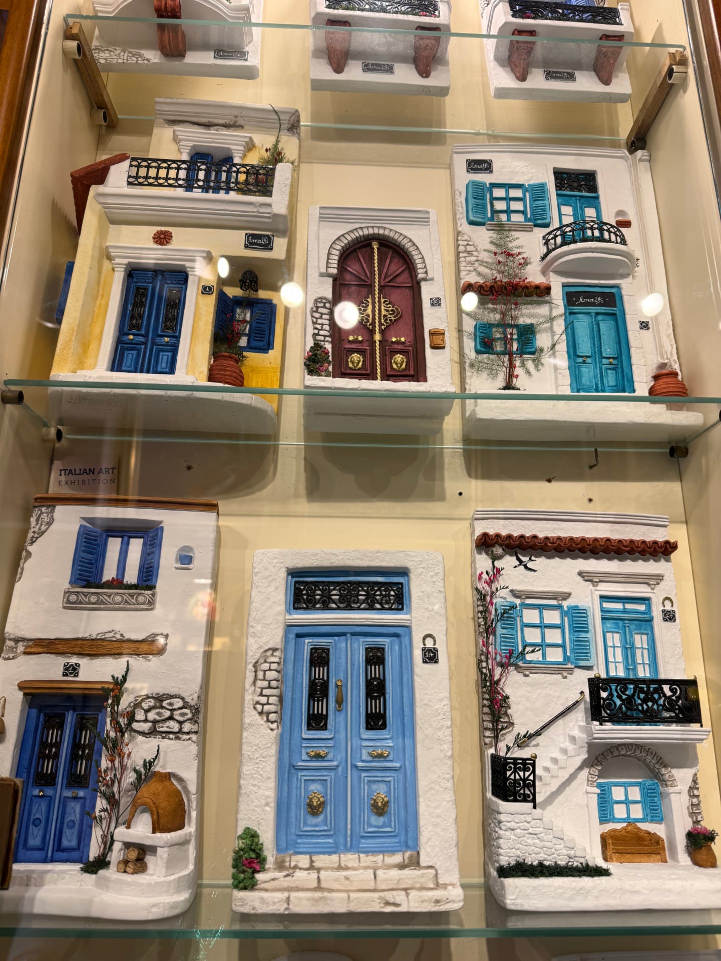 Hand-painted Amalfi ceramic door tiles in a shop display