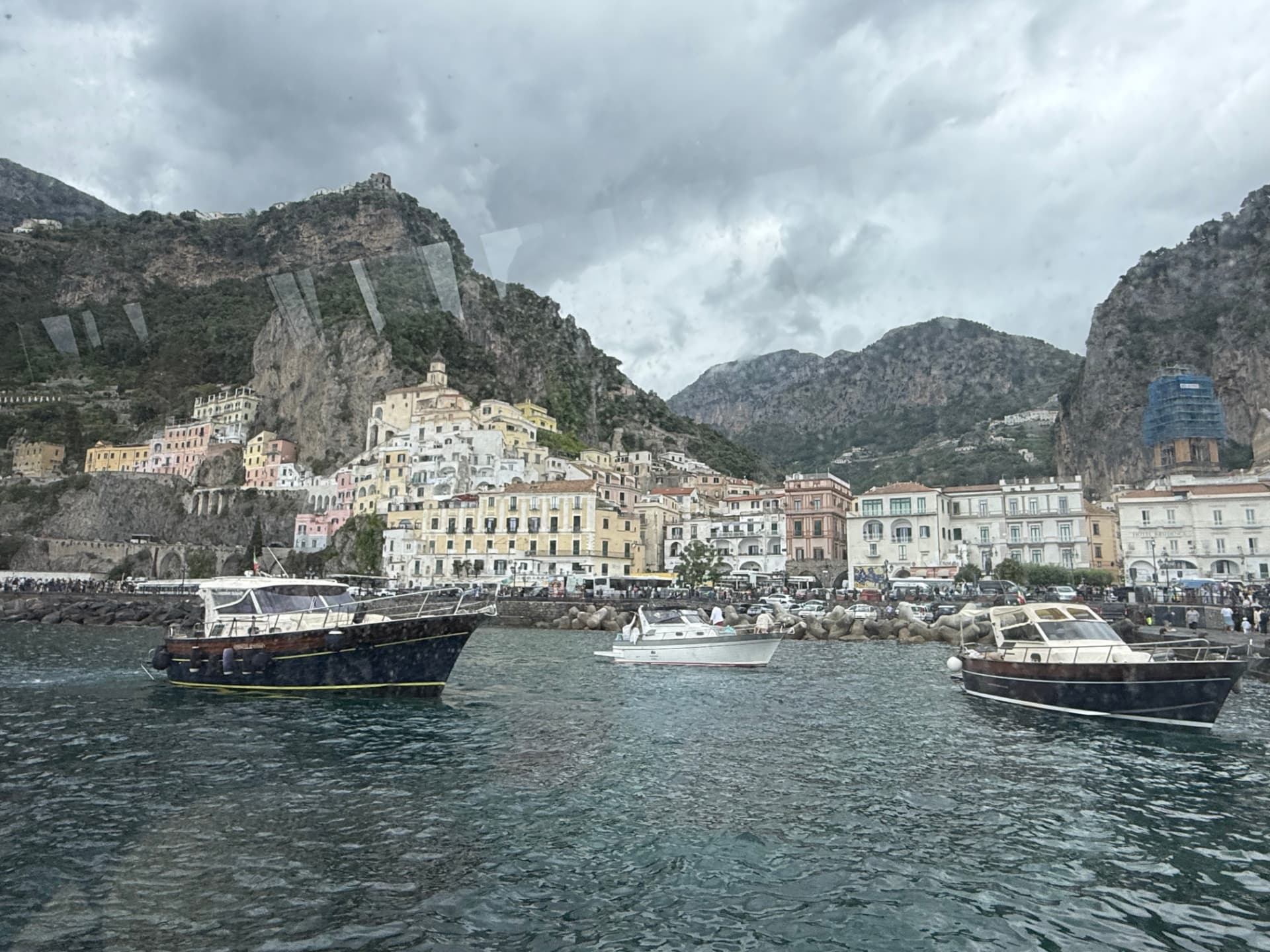 Amalfi seen from the water with boats in the harbor