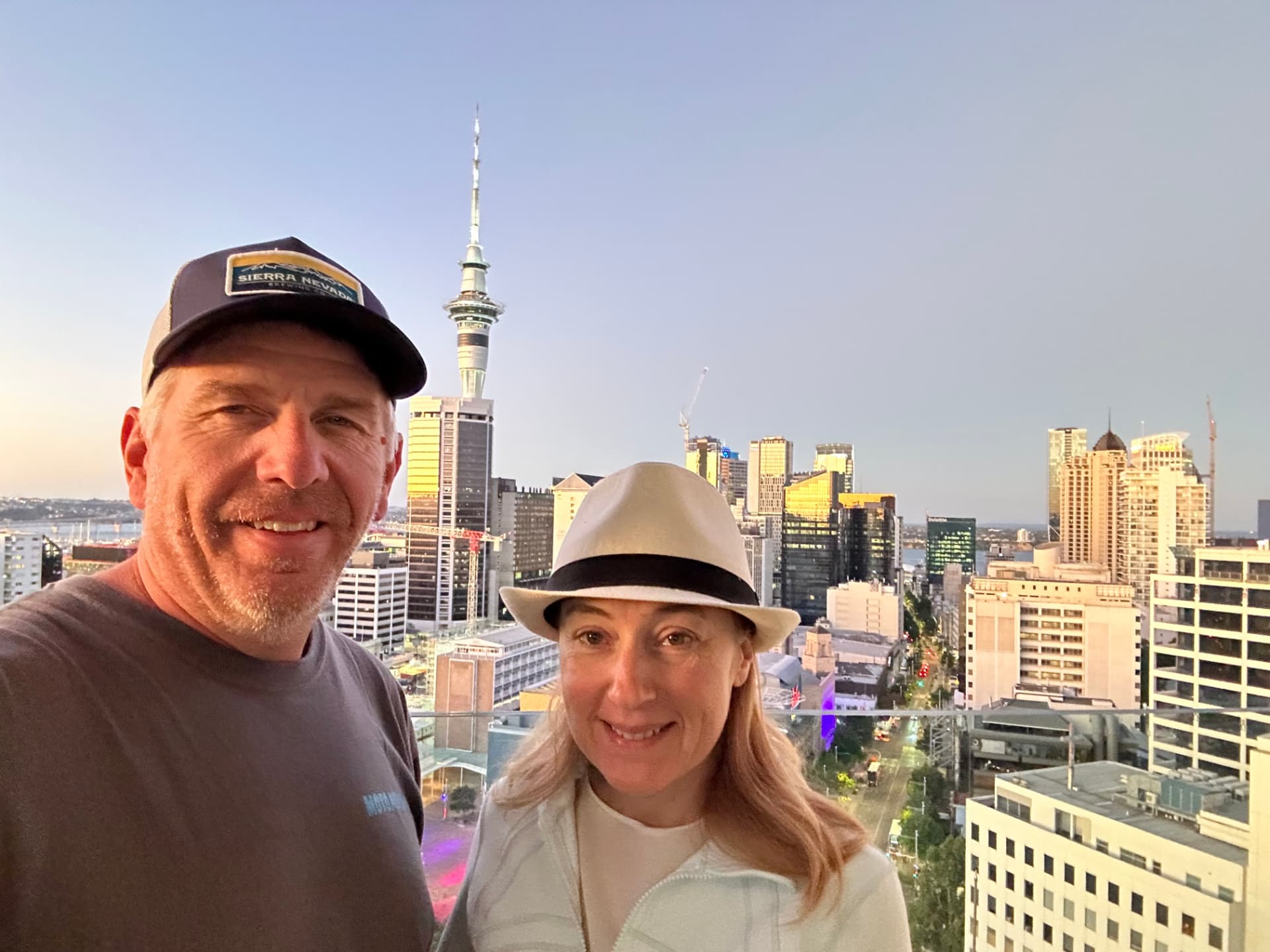 Natalia and her husband on an Auckland rooftop with the Sky Tower behind them