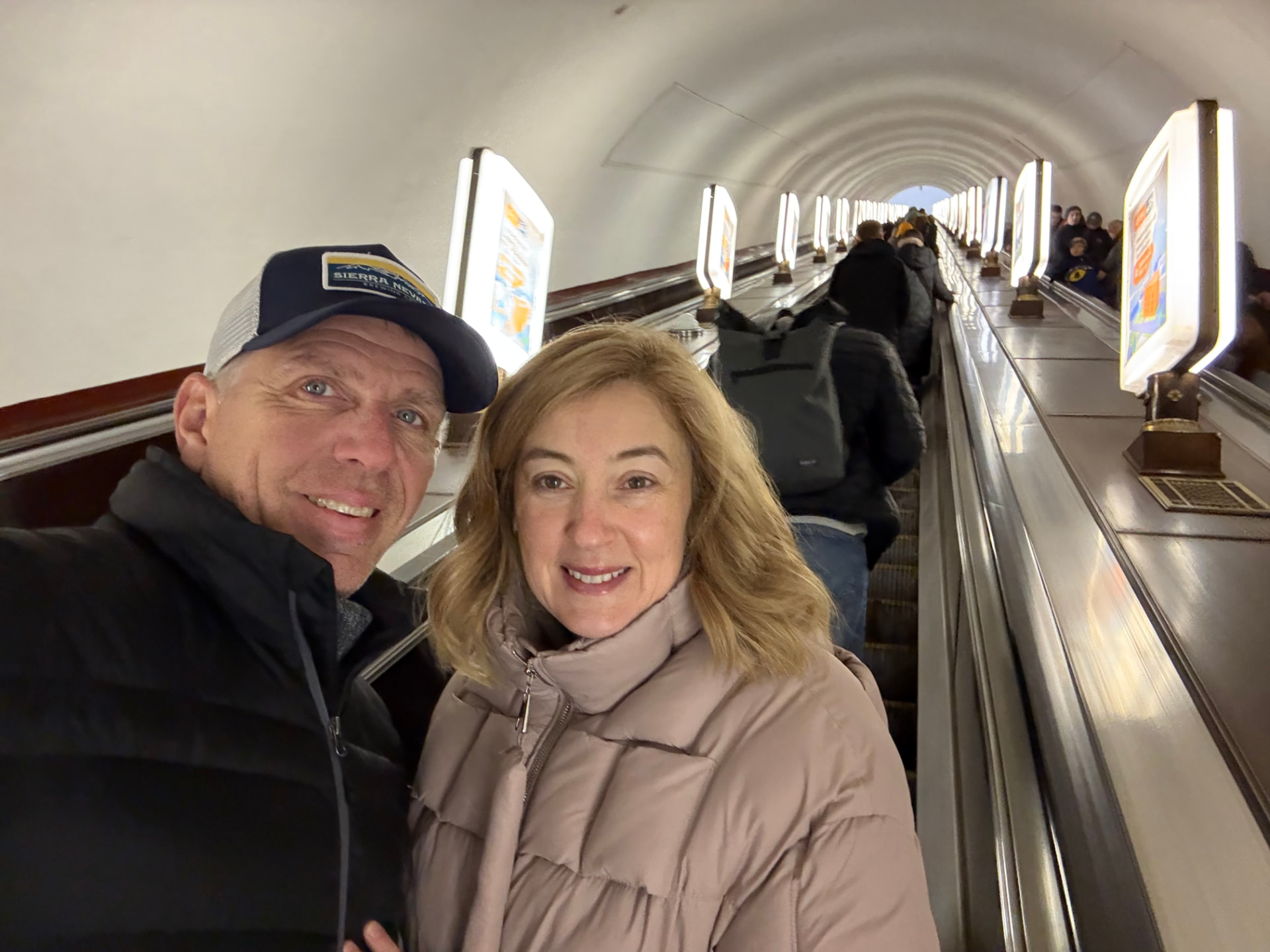 Natalia and her husband on the long escalator of the Kyiv metro